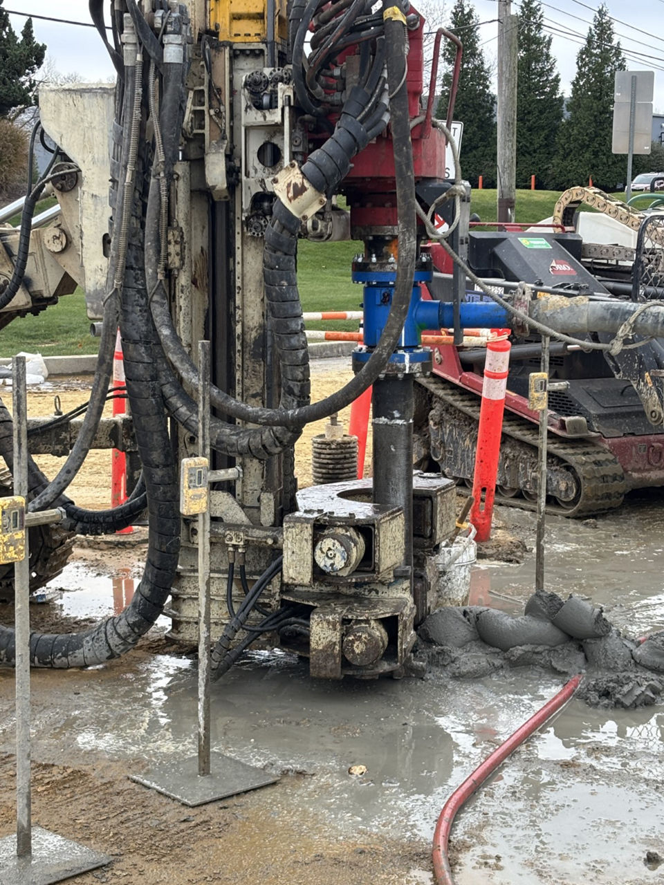 Grout material inserted into hole using machinery