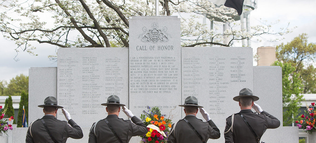 Four PSP honor guard members salute at the memorial wall, PSP Academy, Hershey