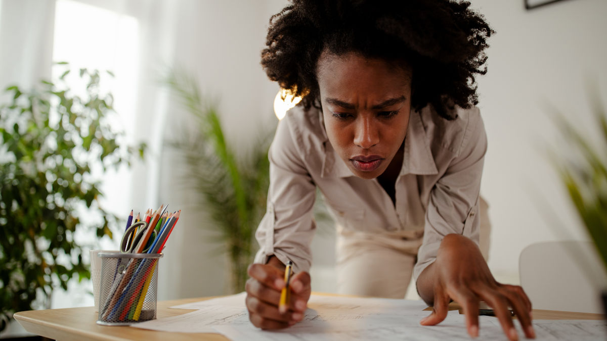 A person working at a desk with a pencil