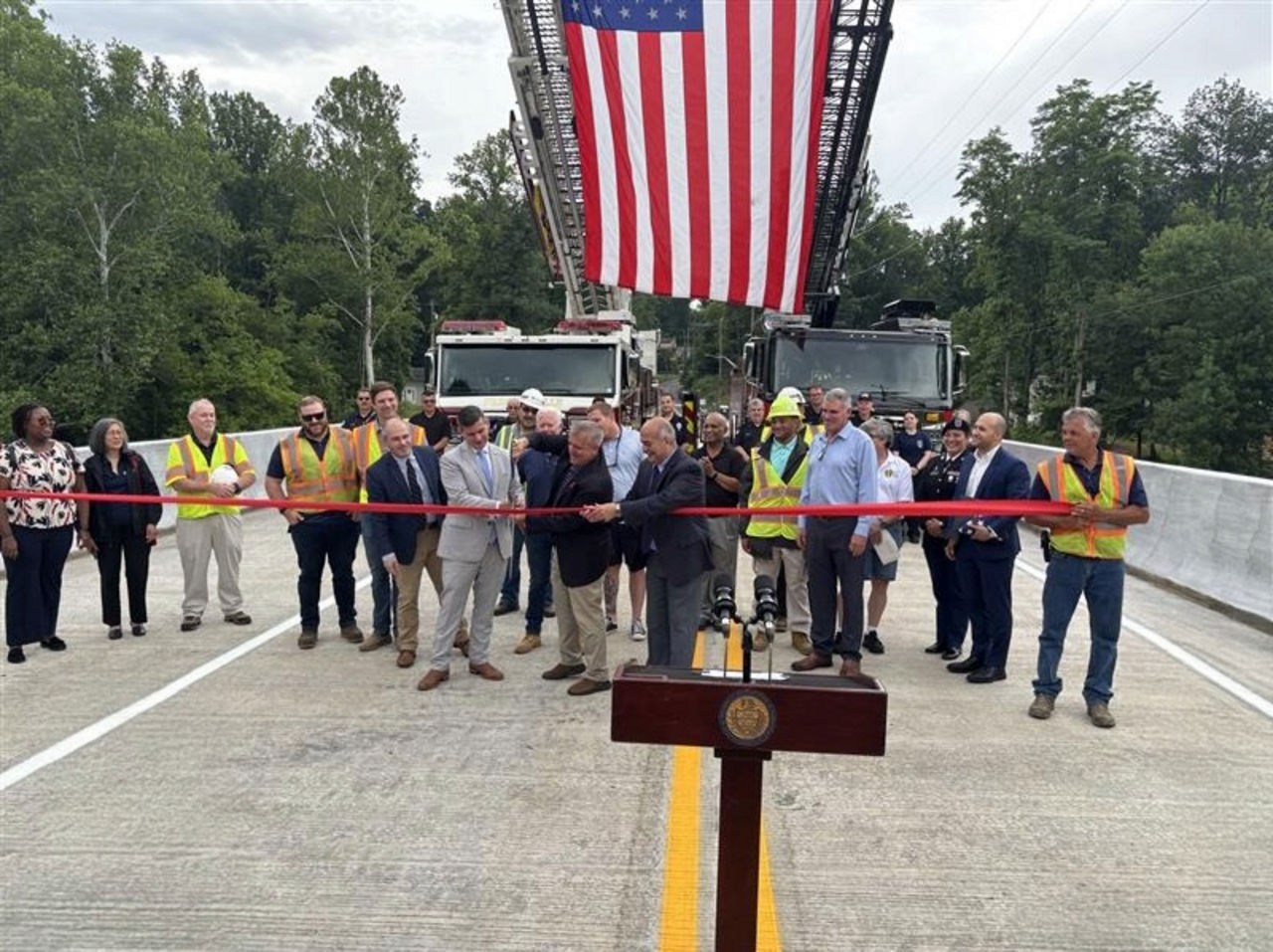 Ribbon cutting re-opening Brownsville Road after completion of the new bridge.