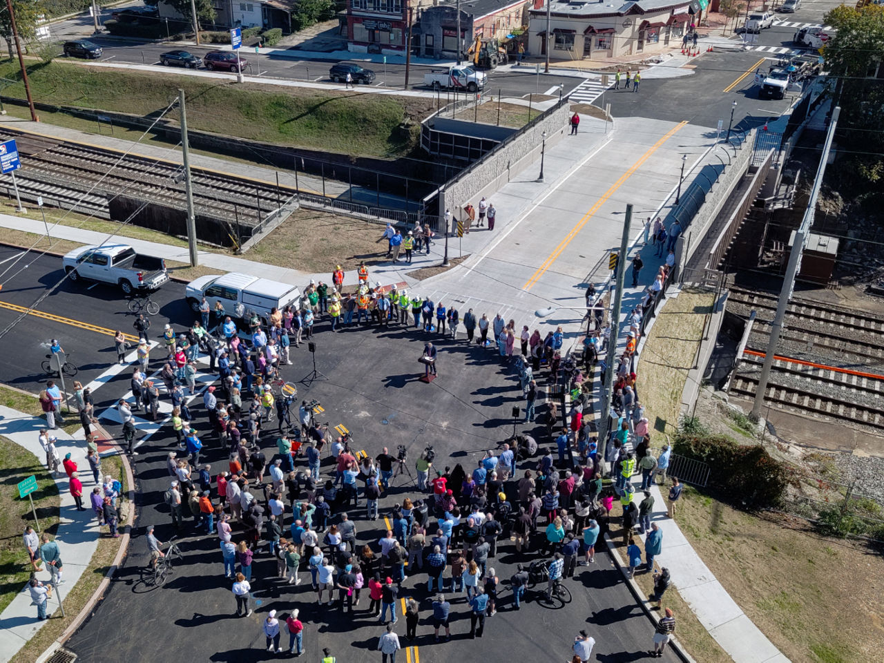 Aerial view of crowd around speaker during Sellers Avenue reopening event.