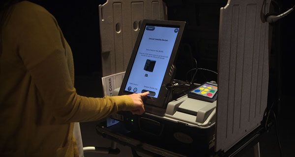 Person making selections on the ballot marking device touchscreen