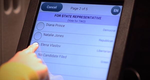 Person making selections on the ballot marking device touchscreen