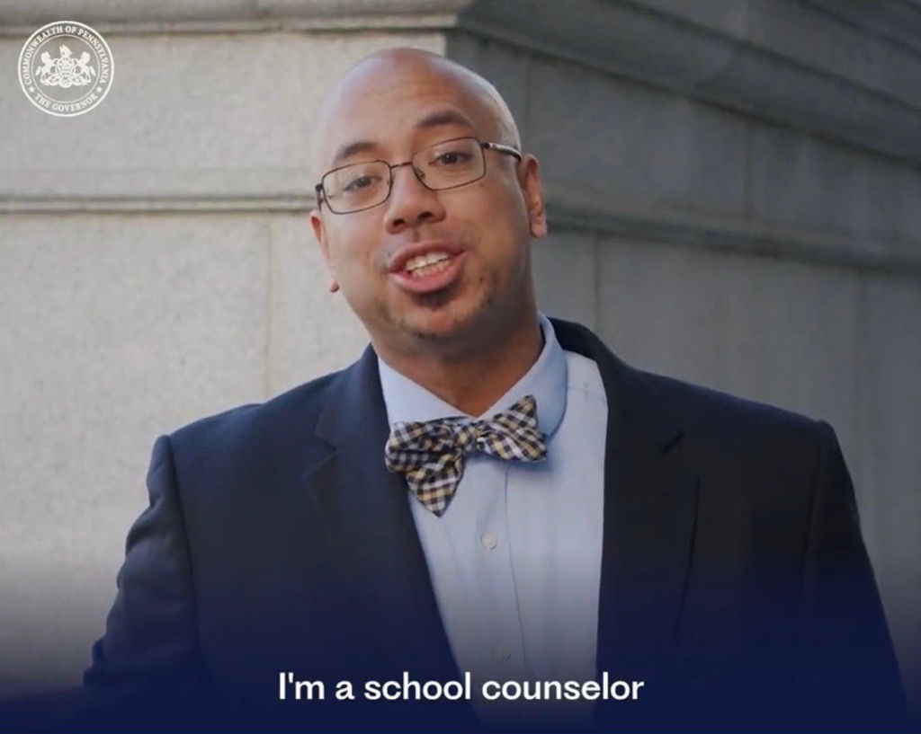 Screenshot of a video of a man with the caption "I'm a school counselor" 