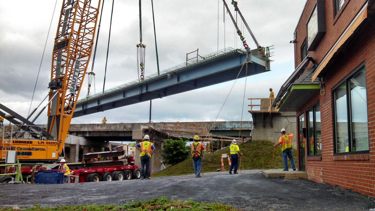 bridge deck being lifted into place.