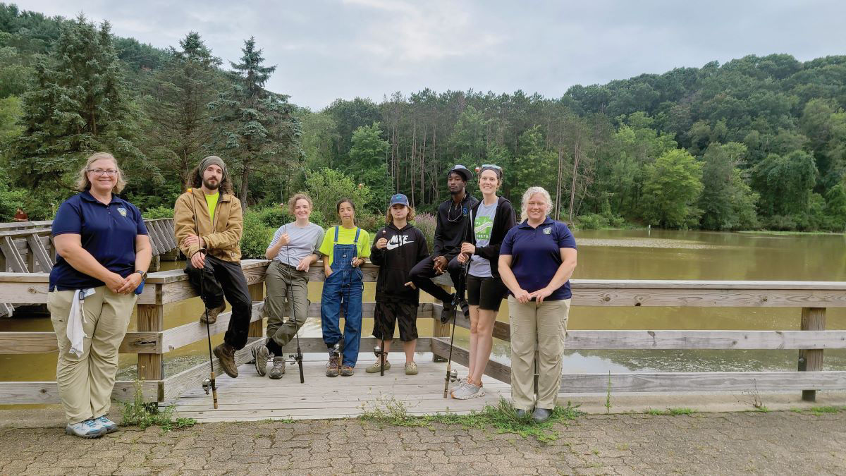 Group of students on a lake with two teachers 