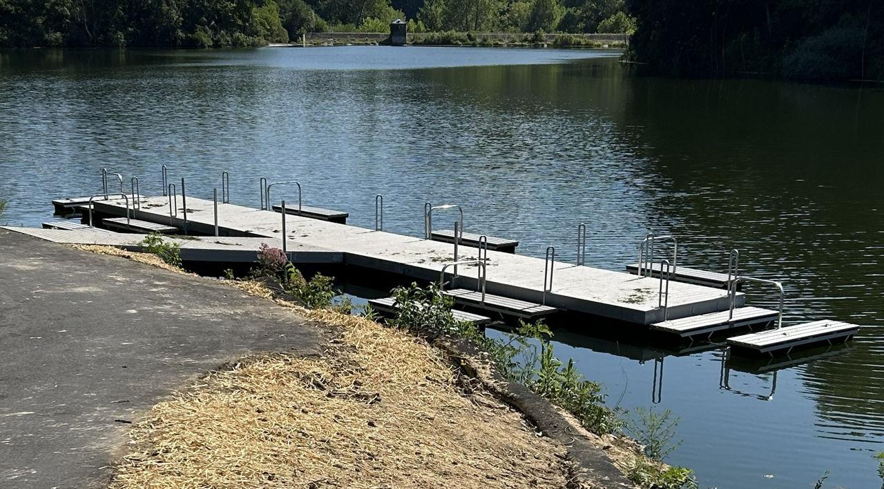 An ADA accessible floating dock with adaptive kayak launches constructed along a lakeshore.