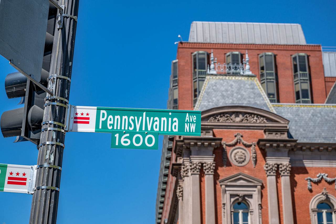A Pennsylvania street sign in front of a historic building on a sunny day