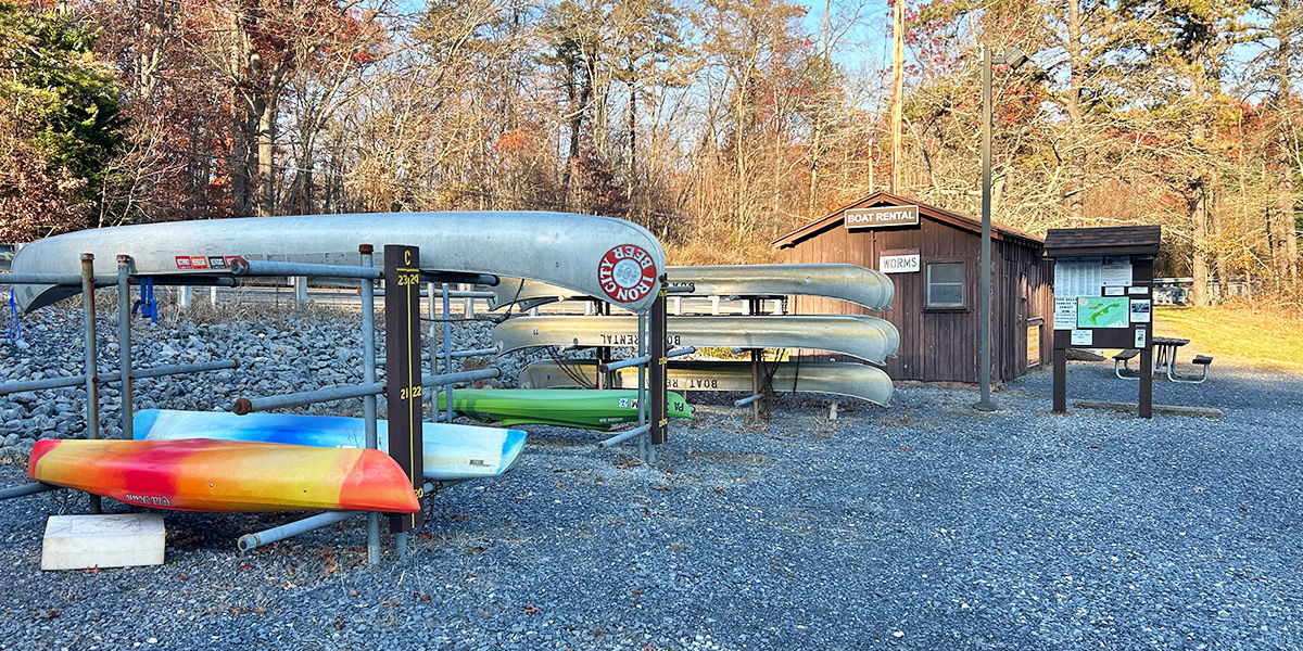 Canoes and Kayaks hanging on racks at the Boat Rental station at Pine Grove Furnace State Park