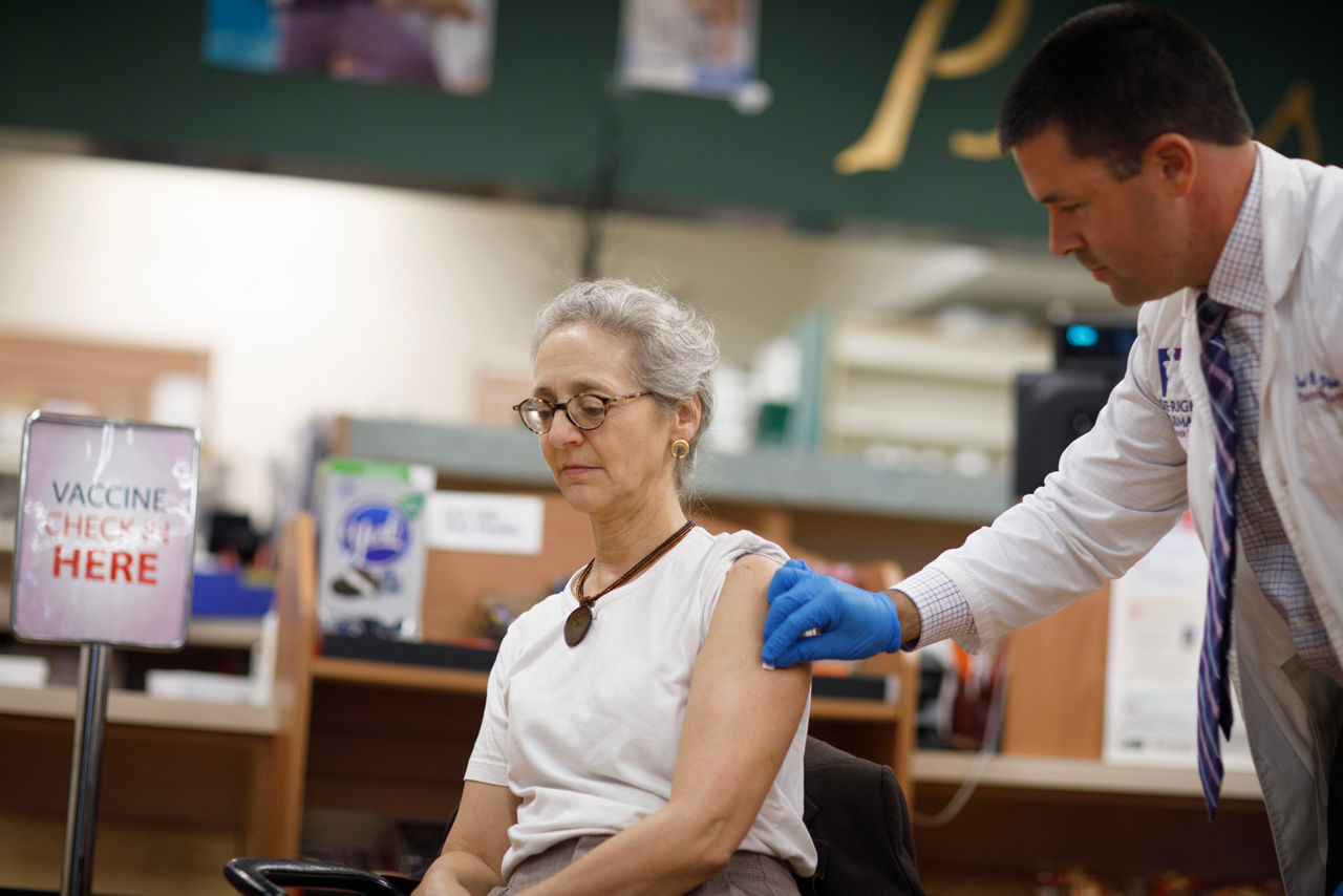 Photo of Secretary of Health Dr. Debra Bogen receiving a COVID-19 vaccine