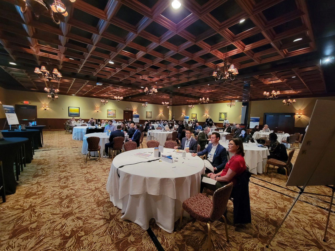 Businesspeople watch a presentation in an elegant banquet room