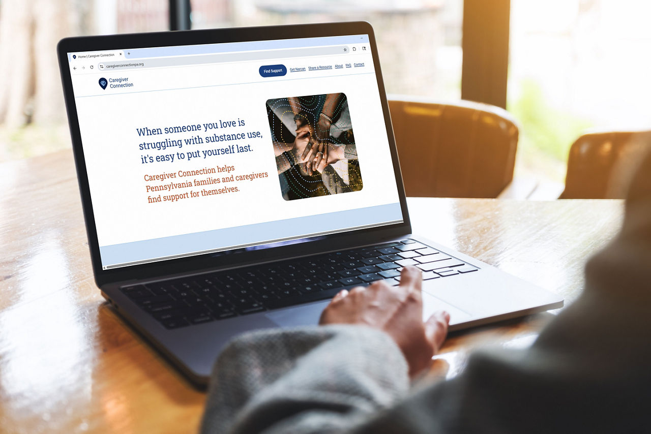 Image of person on a laptop visiting the new Caregiver Connection website