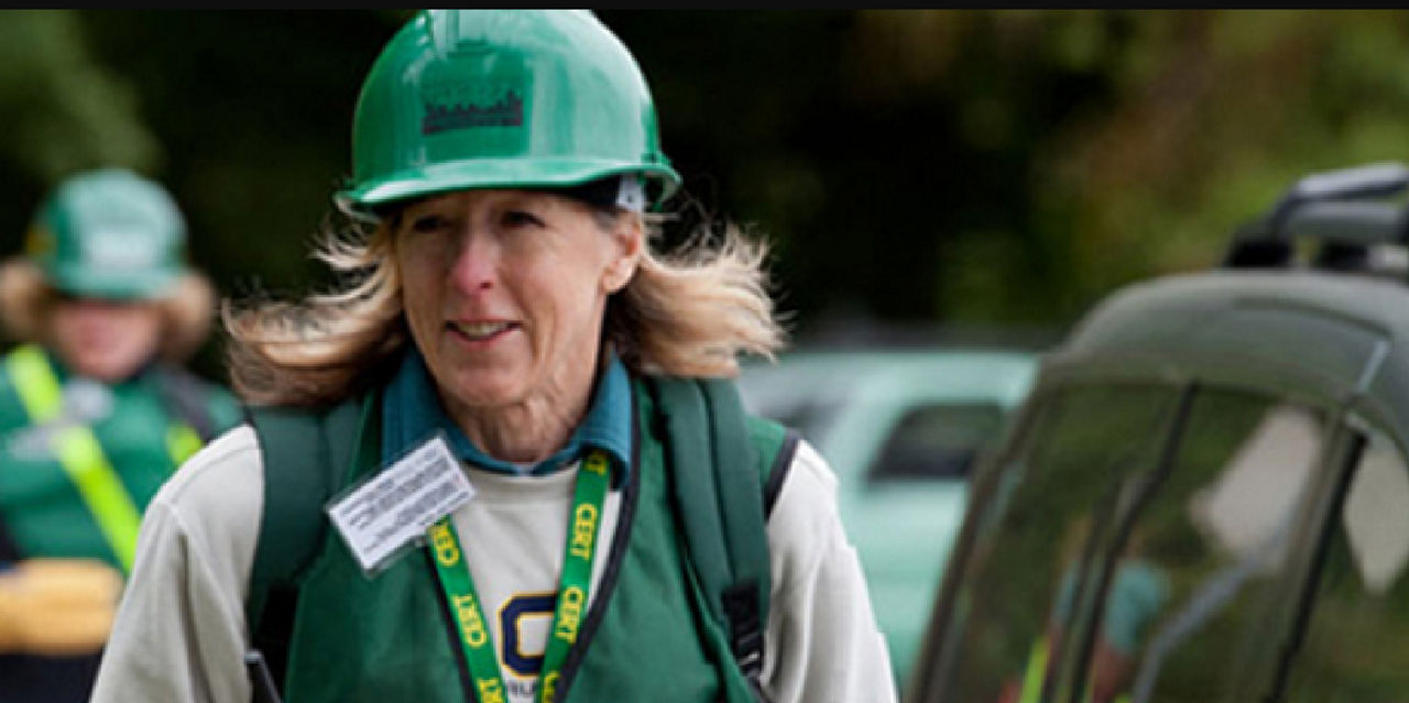 A woman wearing CERT gear volunteers to prepare for disaster.