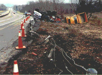 Photo of a collision between two trucks on side of highway