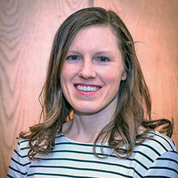 Meredith Graham smiles wearing a white and black striped top