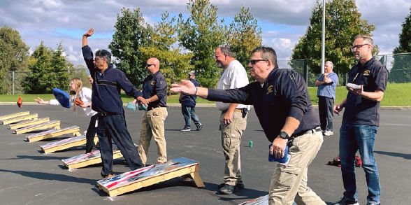 Staff members compete in a rousing game of cornhole.