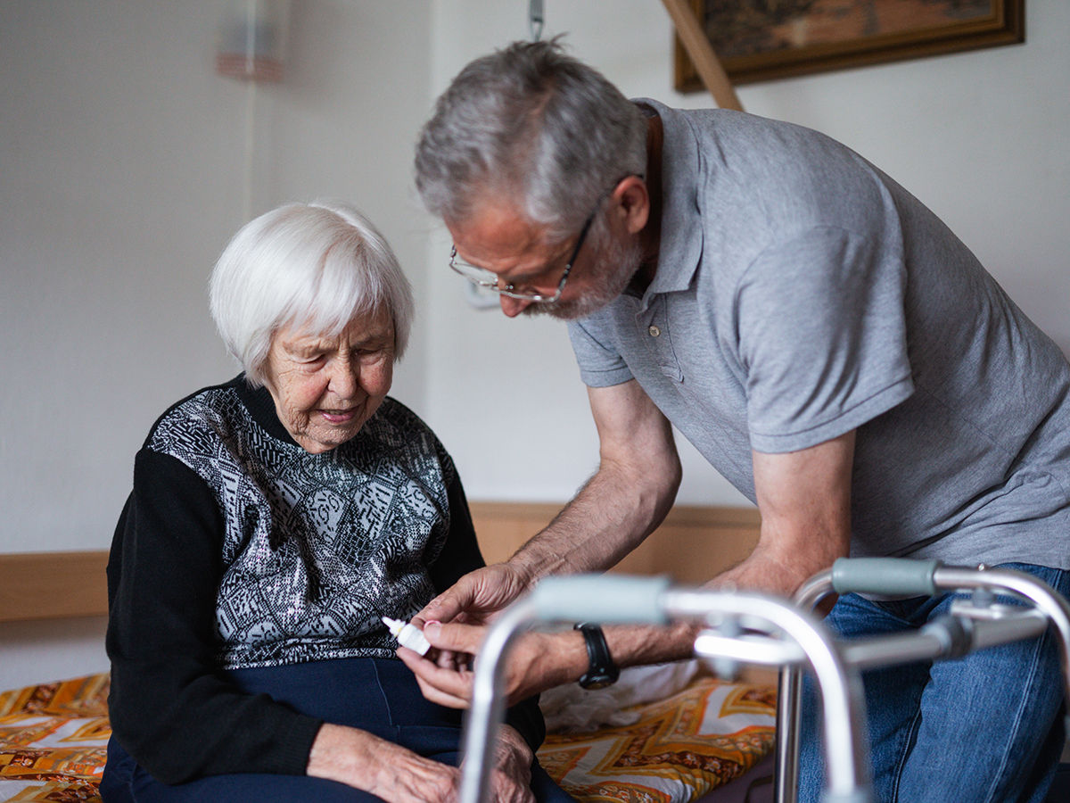 Man is helping an elderly woman with task