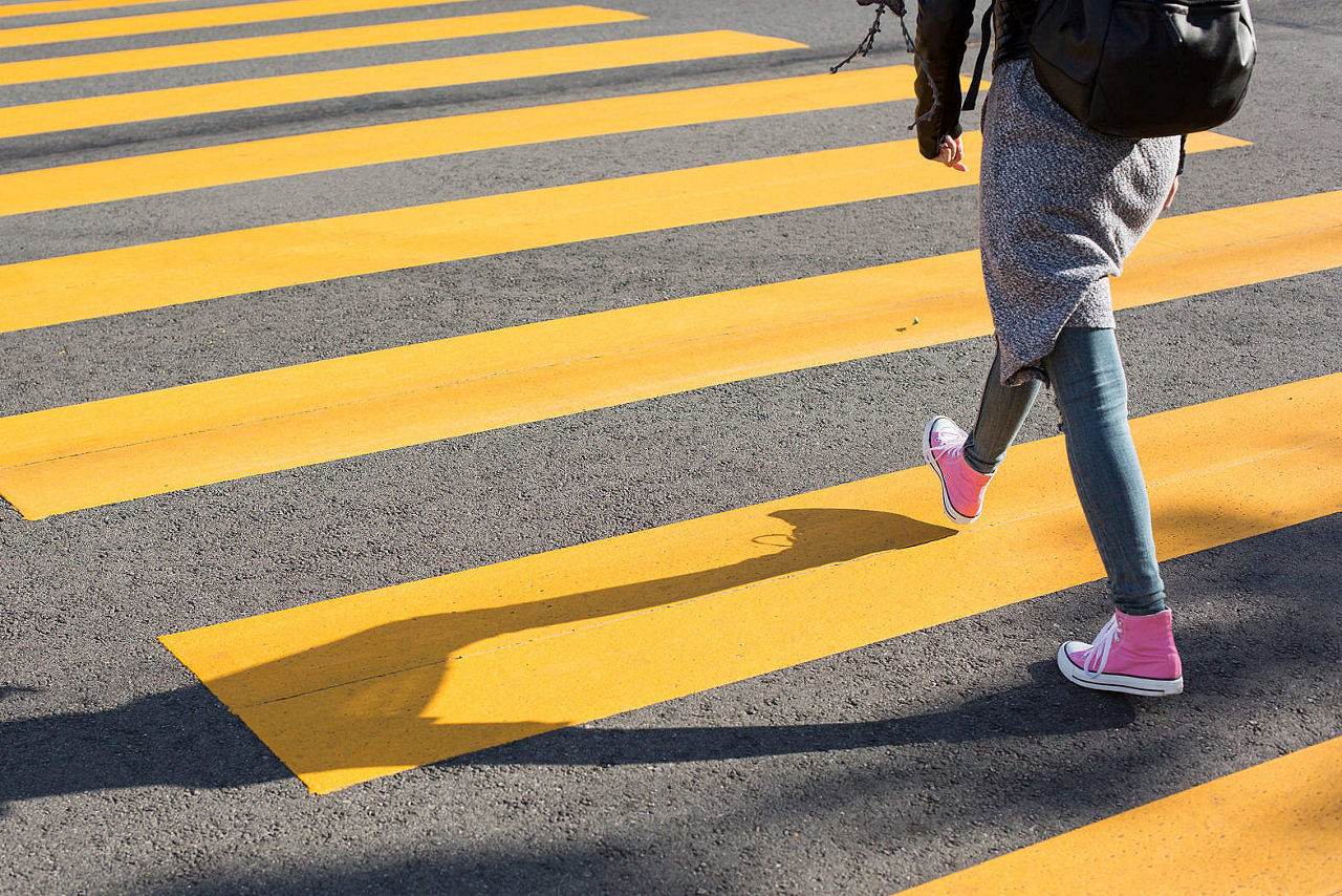 A person uses a crosswalk