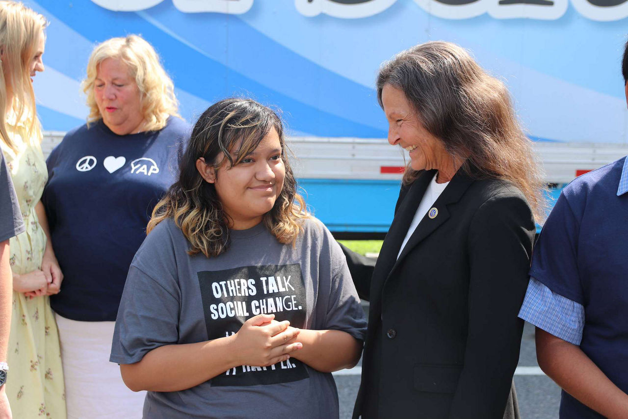 L and I Secretary Nancy A. Walker, smiles while talking to MY Work participant,  while engaged in conversation. 