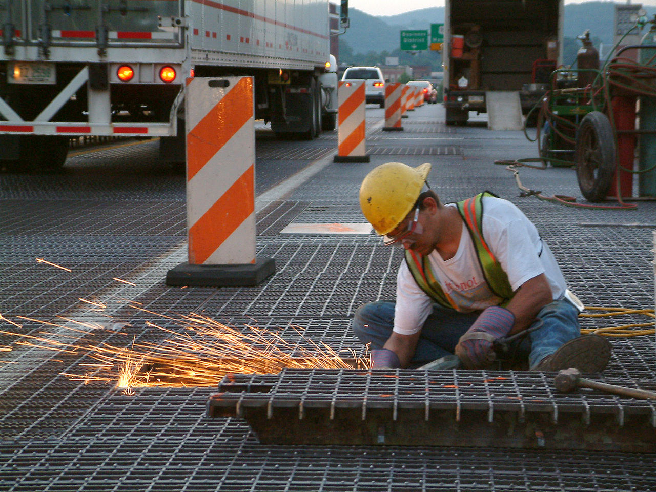 Worker welding bridge decking
