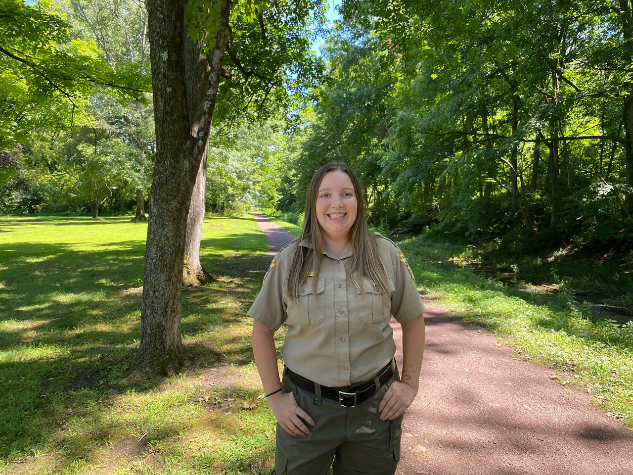 Delaware Canal State Park Assistant Manager Emily Reed Stands on a Trail.