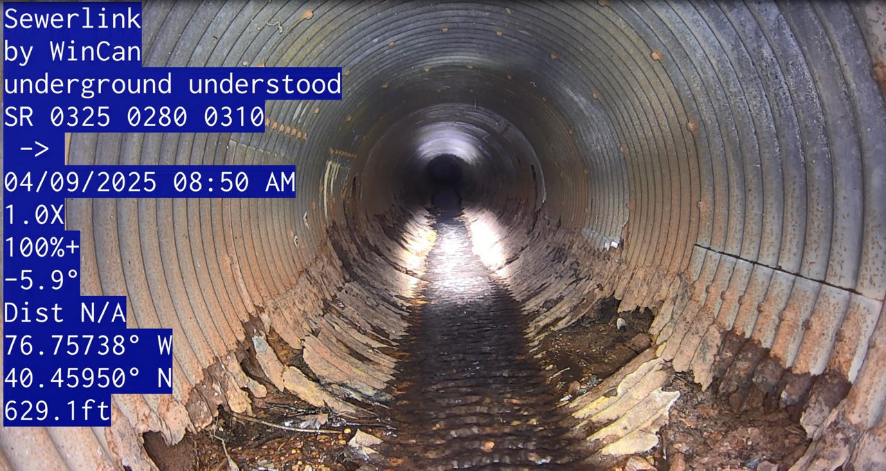 An inside view of a deteriorated section of an underground pipe.