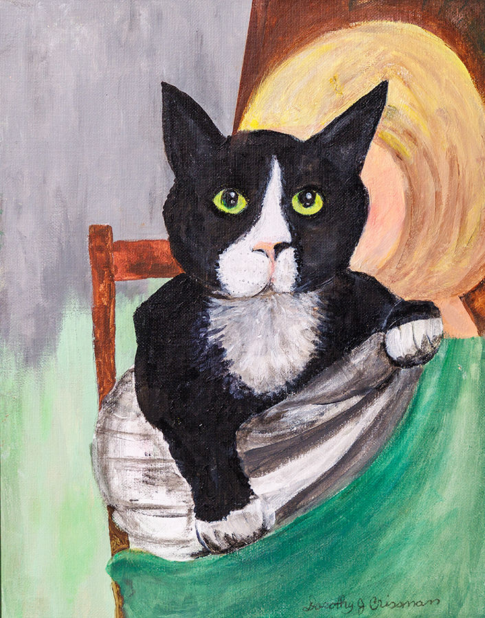 a black cat with a white blaze and green eyes is held by a person