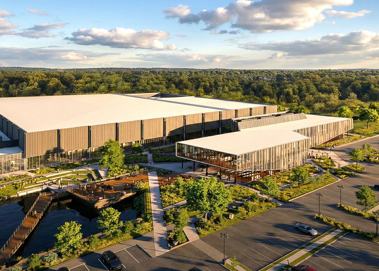 A rendering of a large modern medicine manufacturing campus, surrounded by trees, during sunset.