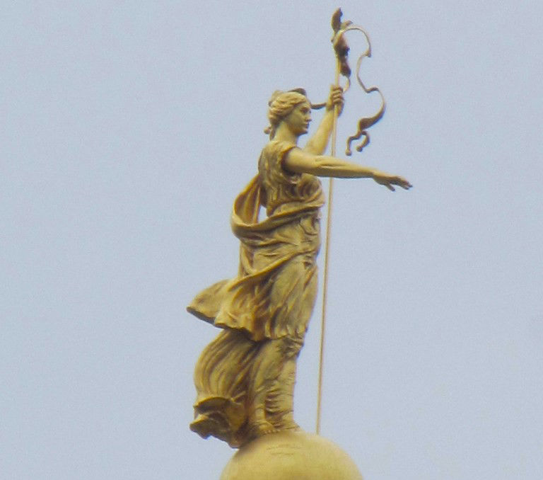 justice statue on top of capital building