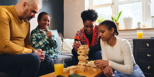 A family plays Jenga together.