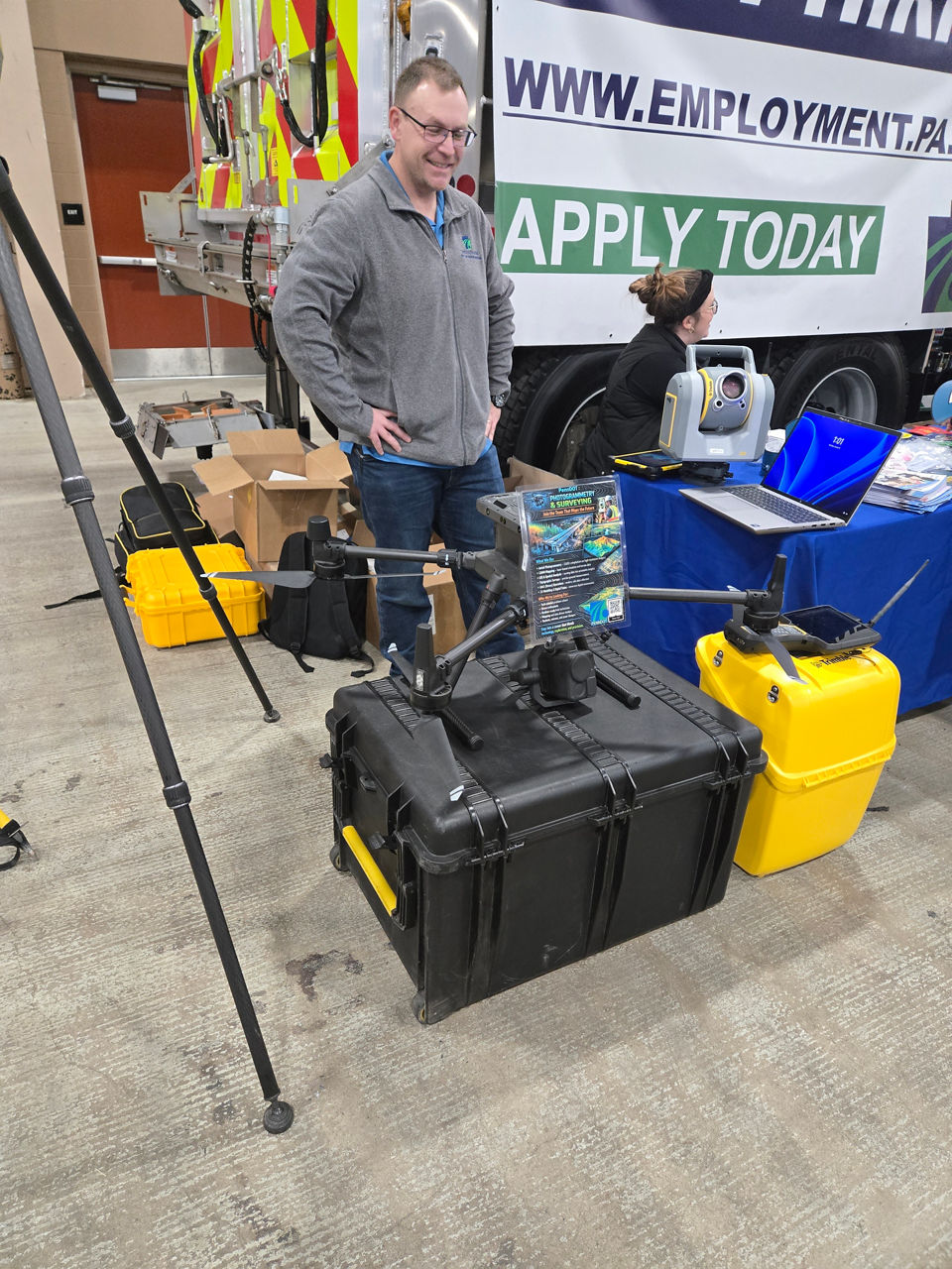 Image of a person standing behind a PennDOT drone being displayed at the Pennsylvania Farm Show. 