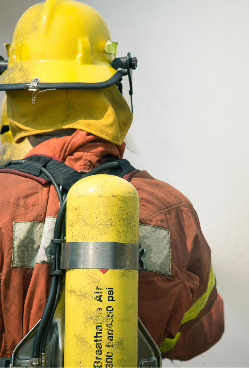 A firefighter with an oxygen pack on his back.