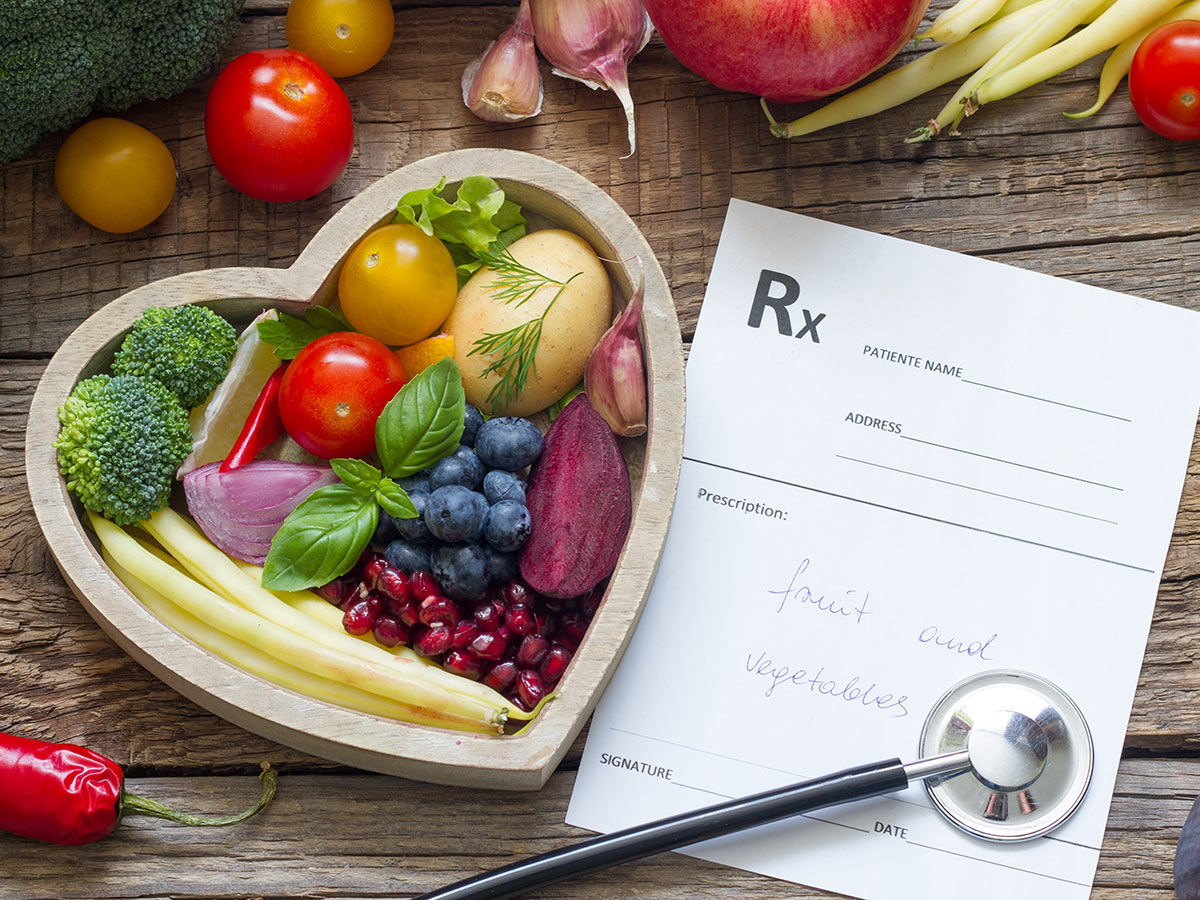Healthy food in heart stethoscope and medical prescription diet and medicine