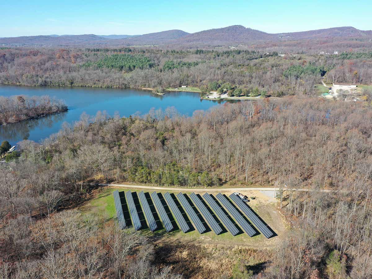 Waves roll in on a beach during sunset.
