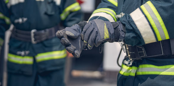 A firefighter equipping his gloves