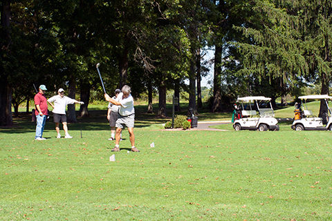 Four men golfing on a sunny day at Evansburg State Park