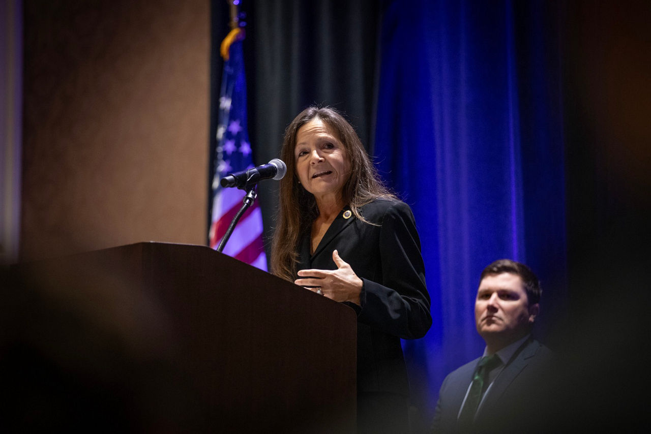 L&I Secretary Nancy A. Walker speaks at a podium to attendees at the Governor's Occupational Safety & Health Conference