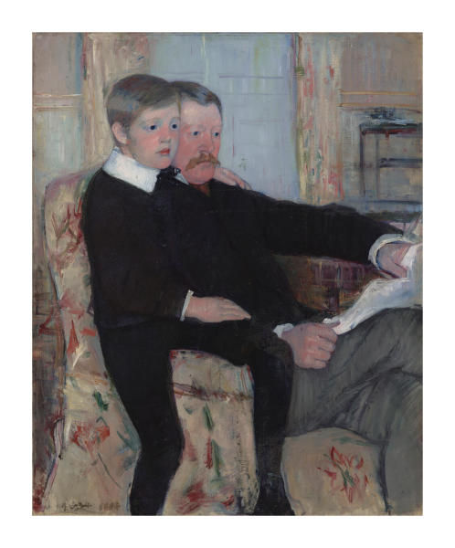 Seated adult and child reading together indoors