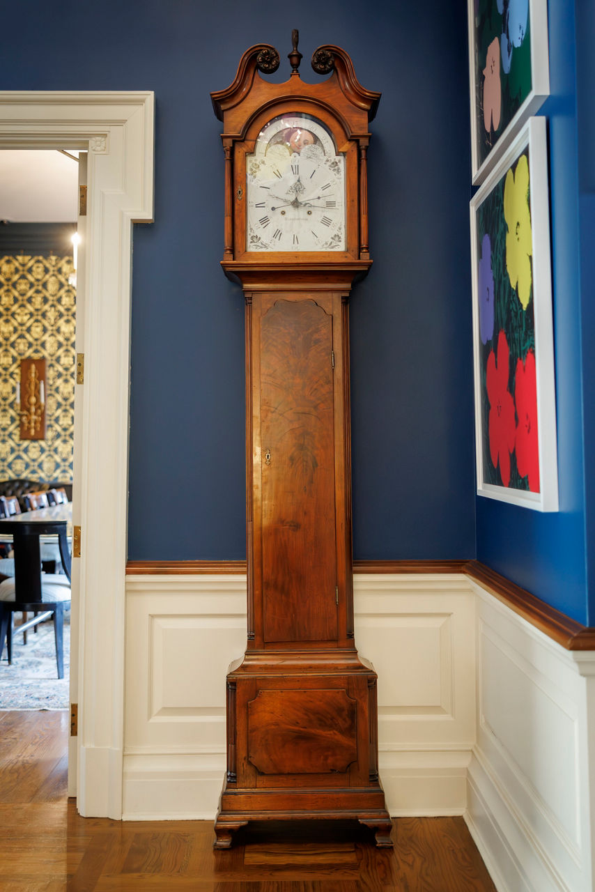 Antique wooden grandfather clock in blue walled room