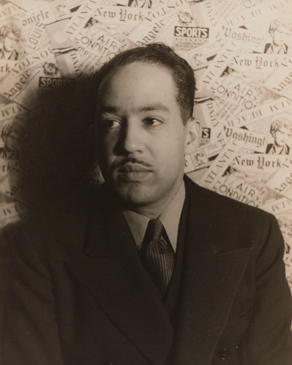 Man in suit with vintage newspaper collage backdrop