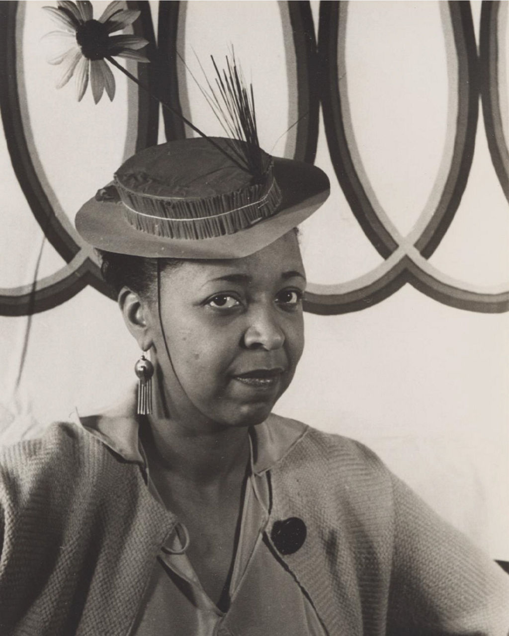 Woman in vintage attire with floral hat and brooch
