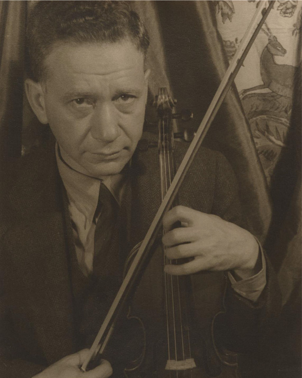 Sepia portrait of man playing violin indoors