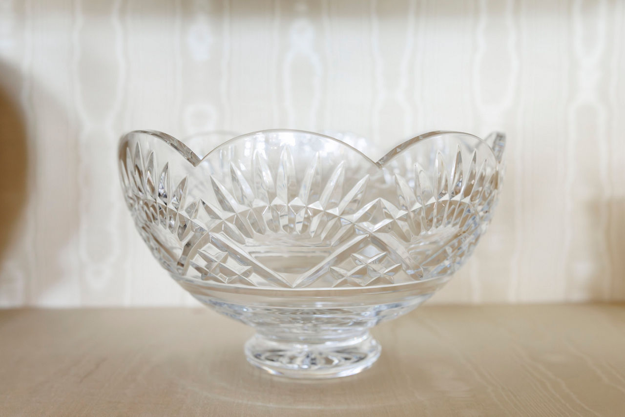 A clear crystal bowl with intricate cut patterns.
