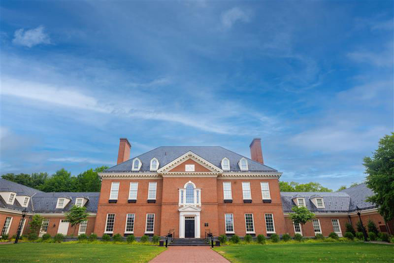 The Residence on a sunny day with a blue sky and wispy clouds