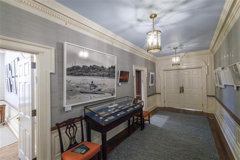Hallway with art and display case 