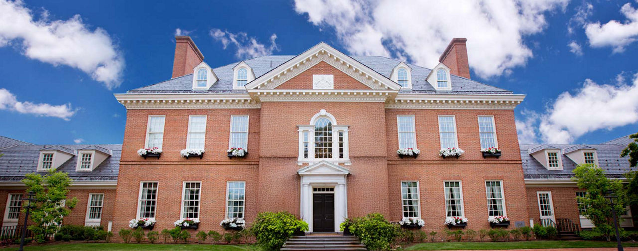 The Residence on a sunny day with a blue sky and fluffy clouds