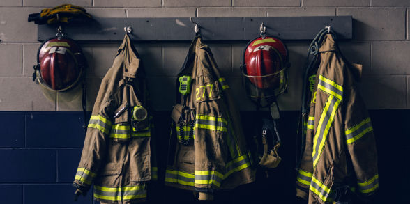 image of firefighter equipment hanging on a wall