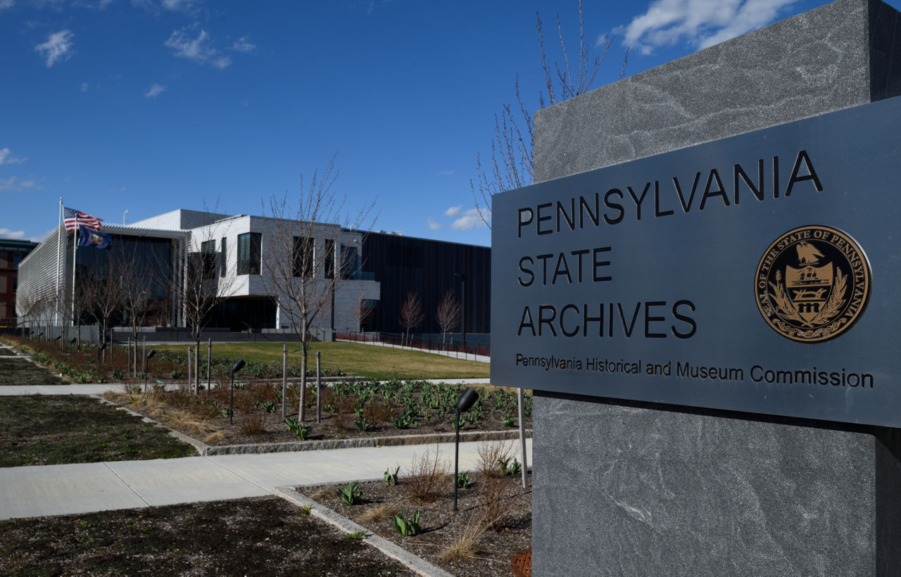 An exterior view of the Pennsylvania State Archives, featuring a sign identifying the archives in the foreground