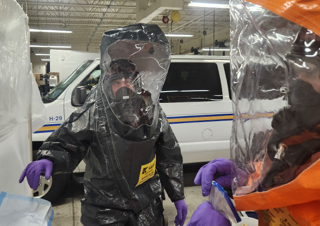 A member of the HAZMAT team wears full protective gear during a training.