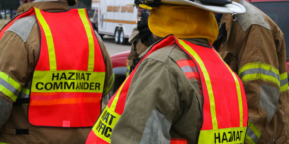 A team wearing HAZMAT vests responds to an incident.